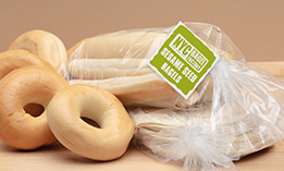 Bakery goods sitting on table in a bag closed with a Kwik Lok closure and label