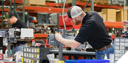 Kwik Lok employee working on machine