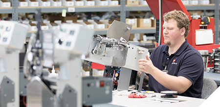 Kwik Lok employee working on printer