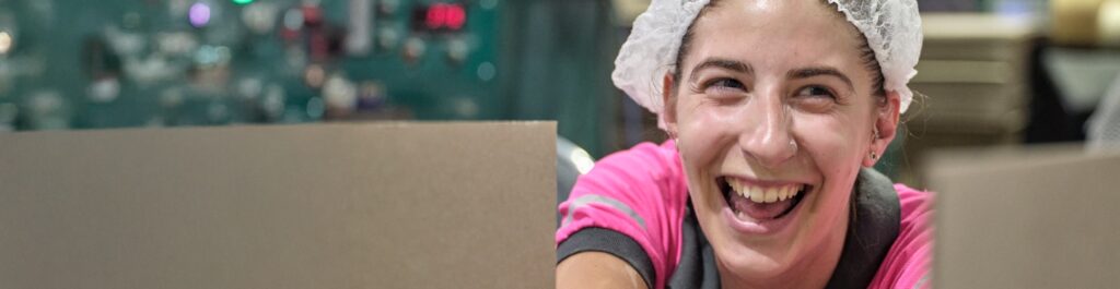 Well-being hero - smiling woman in hair net and pink shirt